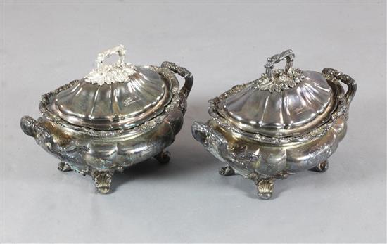 A pair of 19th century Sheffield plate two handled soup tureens and liners, engraved with the Heneage family crest, 39cm.